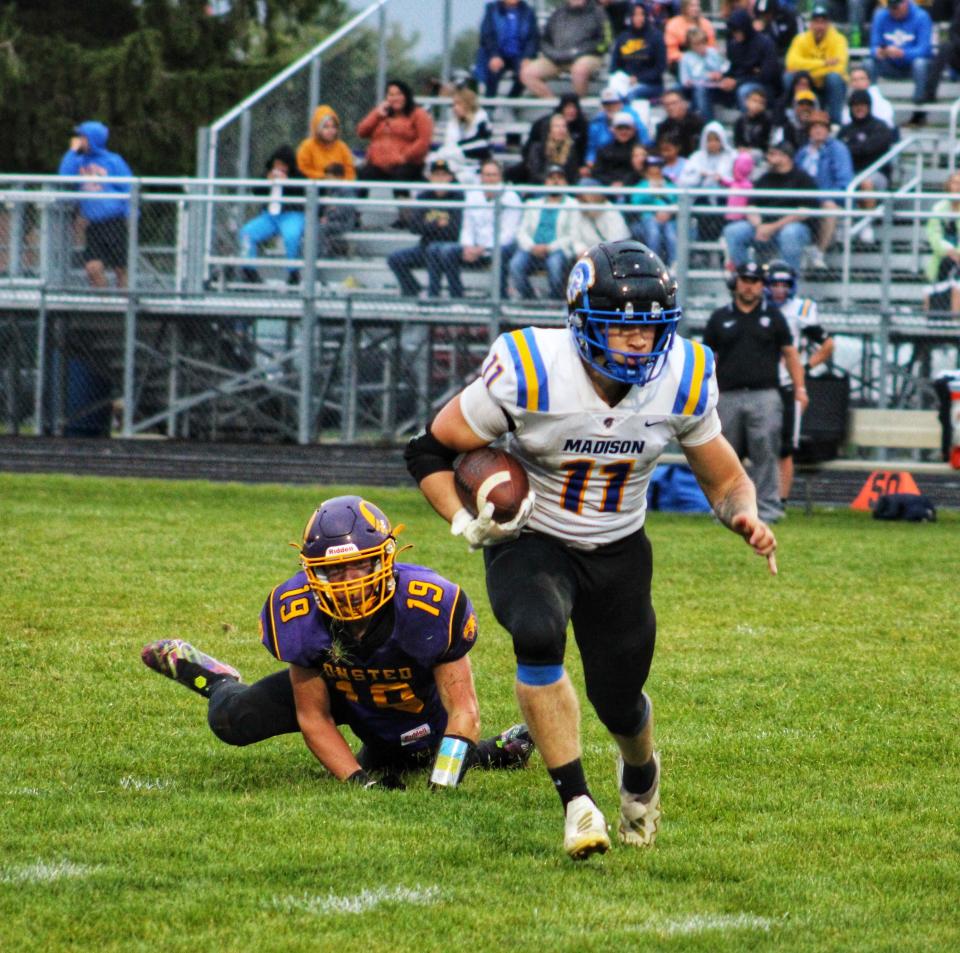 Madison's Caleb DeLeon carries the ball during Friday's game at Onsted.