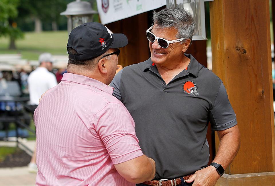 Zane Gross talks with former Cleveland Browns defensive lineman Frank Stams at the Wendy's Golf Classic Friday, June 25, 2021 at the Ashland Golf Club. TOM E. PUSKAR/TIMES-GAZETTE.COM