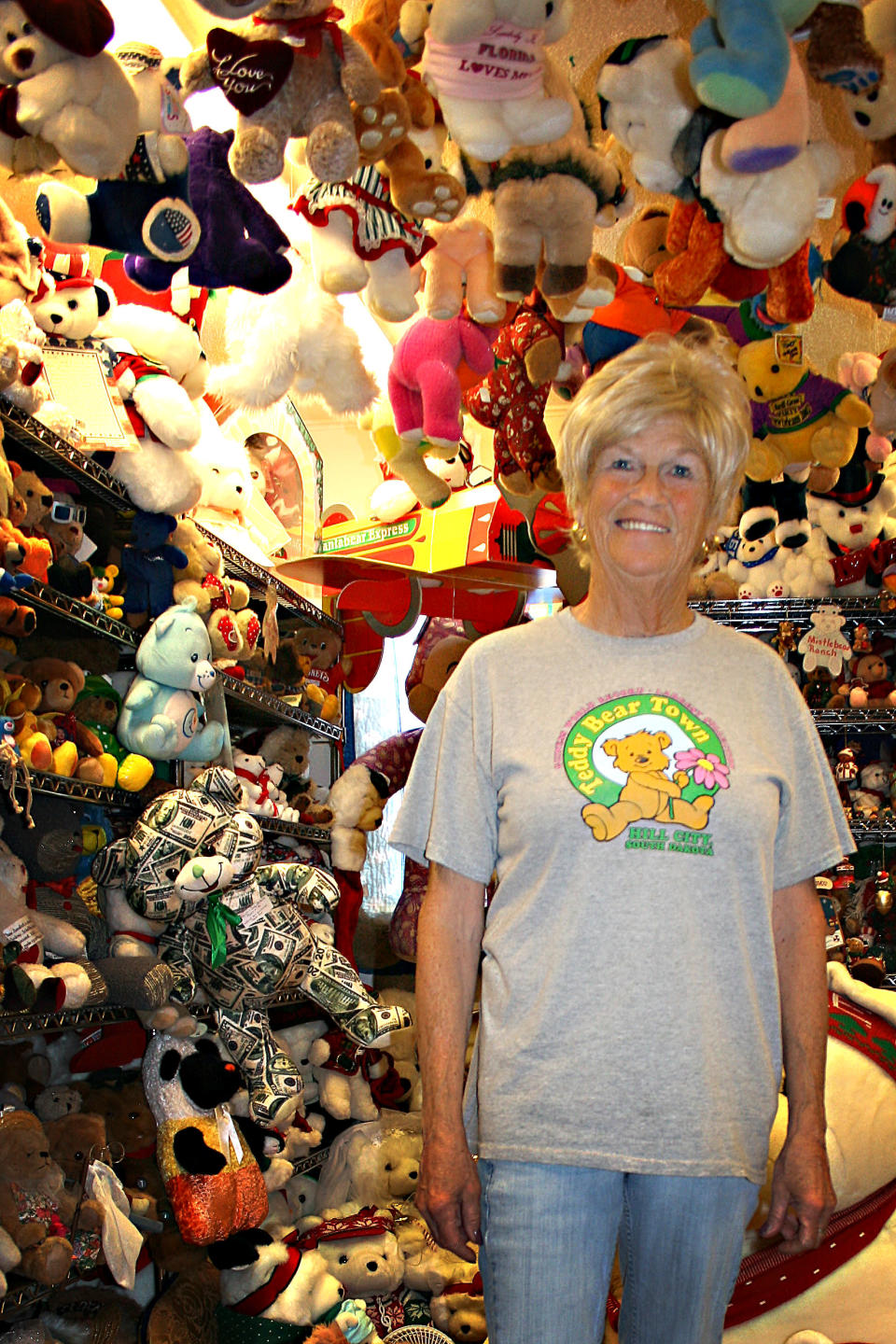 Jackie Miley, 63, is surrounded by teddy bears in this July 21, 2012, photo at Teddy Bear Town in Hill City, S.D. With 7,790 teddy bears in her collection, Miley holds the Guinness World Record for largest teddy bear collection. (AP Photo/Kristi Eaton)