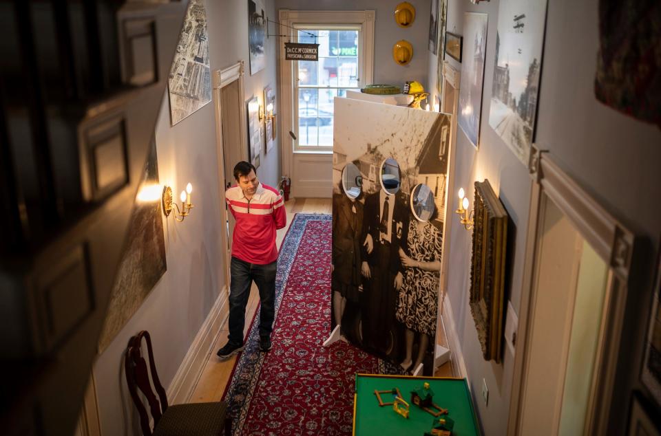 Matthew Graff, assistant curator at the Dearborn Historical Museum Commandant's Quarters, walks inside the museum in Dearborn on Friday, April 19, 2024.