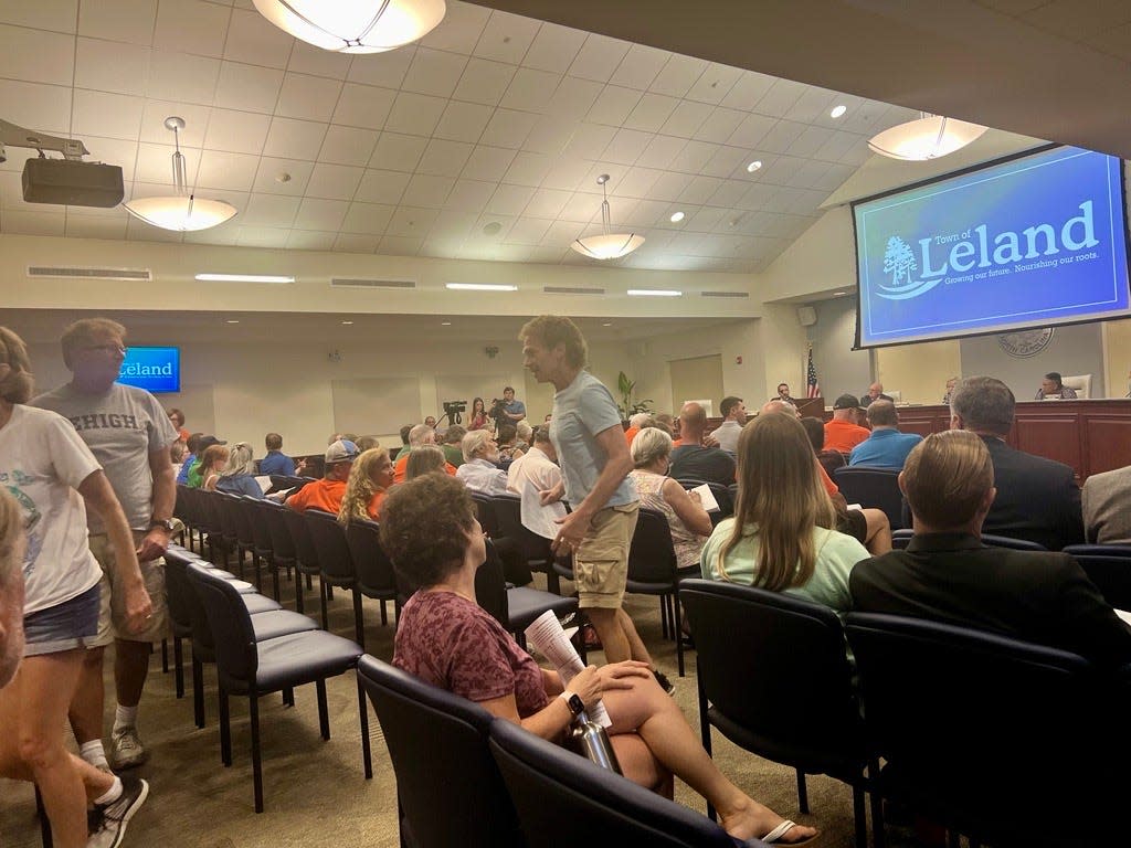 A crowd of Leland residents stood to leave the regular town council meeting on Thursday, May 16, 2024, after the council approved a budget for the 2024-25 fiscal year.
