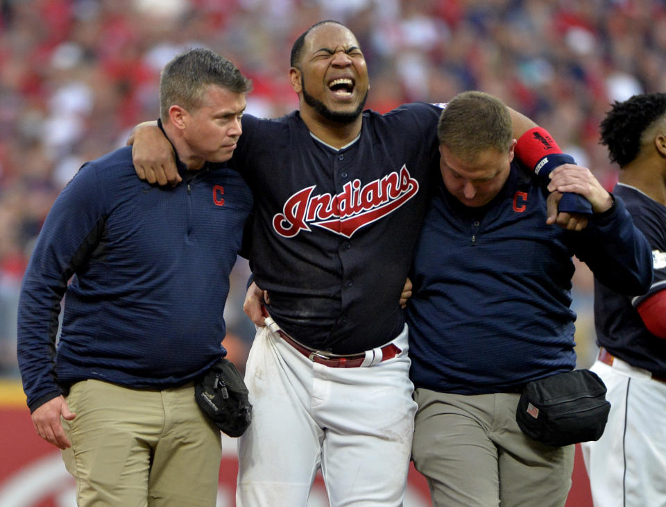 Indians' star Edwin Encarnacion is carried off the field after rolling his ankle at second base in the first inning of Game 2 of the ALDS. (AP)