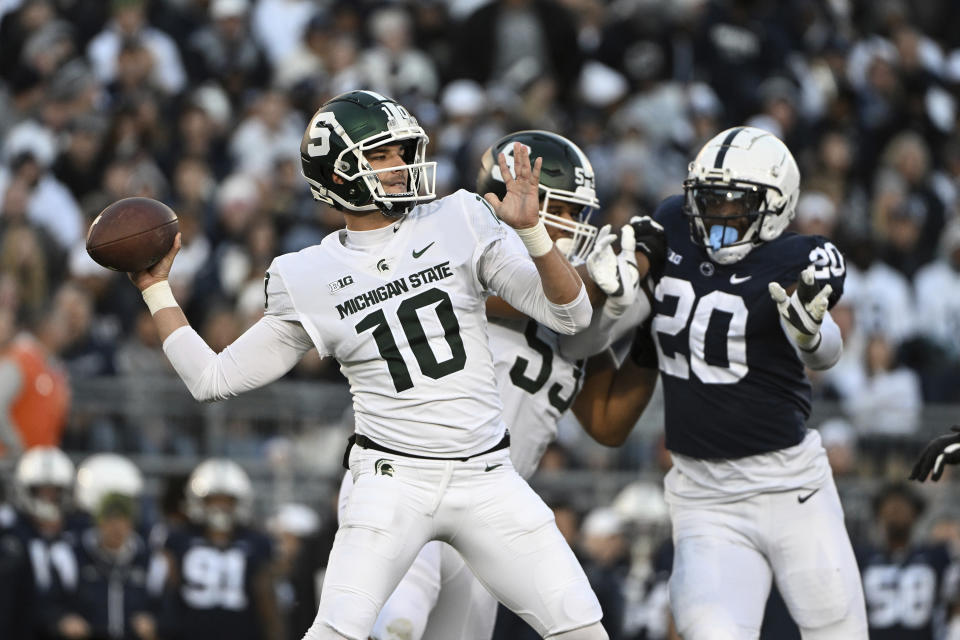 Michigan State quarterback Payton Thorne (10) looks to throw a pass while pressured by Penn State defensive end Adisa Isaac (20) during the first half of an NCAA college football game, Saturday, Nov. 26, 2022, in State College, Pa. (AP Photo/Barry Reeger)