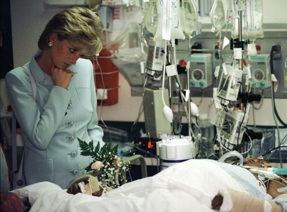 FILE - Princess Diana pauses at the bed of a seriously injured man as she visits Cook County Hospital in Chicago June 5, 1996. Above all, there was shock. That’s the word people use over and over again when they remember Princess Diana’s death in a Paris car crash 25 years ago this week. The woman the world watched grow from a shy teenage nursery school teacher into a glamorous celebrity who comforted AIDS patients and campaigned for landmine removal couldn’t be dead at the age of 36, could she? (Beth A. Keiser, Pool Photo via AP, File)