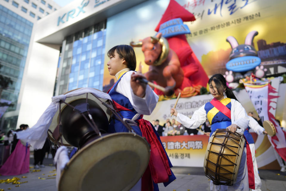 Dancers in traditional costumes perform to celebrate the opening for the Year 2023 trading outside of the Korea Exchange in Seoul, South Korea, Monday, Jan. 2, 2023. (AP Photo/Lee Jin-man)