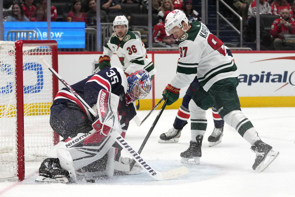 Washington Capitals goaltender Darcy Kuemper (35) makes a save against Minnesota Wild left wing Kirill Kaprizov (97) during the second period of an NHL hockey game Friday, Oct. 27, 2023, in Washington. (AP Photo/Mark Schiefelbein)
