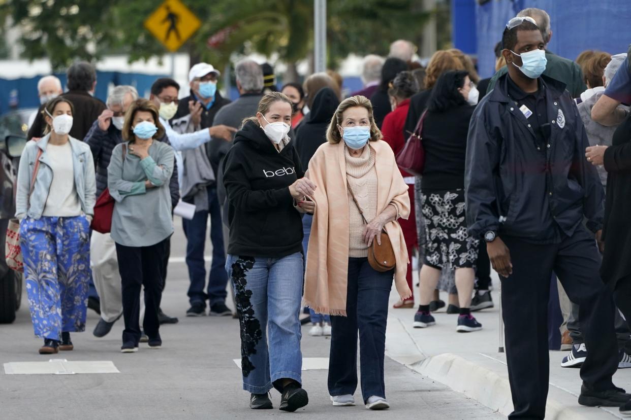 People arrive at Jackson Memorial Hospital to receive the COVID-19 vaccine, Wednesday, Jan. 6, 2021, in Miami. The push to vaccinate people over age 65 in Florida is drawing thousands of eager seniors in uneven rollouts across various counties.