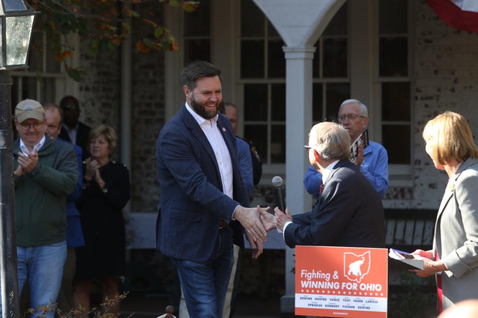 Senate Candidate J.D. Vance shakes hands with Ohio Governor Mike DeWine before taking the podium during a Republican rally at Bryan Place on Thursday.