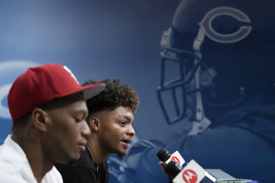 Chicago Bears quarterback Justin Fields, right, speaks as wide receiver DJ Moore listens during a news conference at the NFL football team’s training camp in Lake Forest, Ill., Tuesday, July 25, 2023. (AP Photo/Nam Y. Huh) ORG XMIT: ILNH111