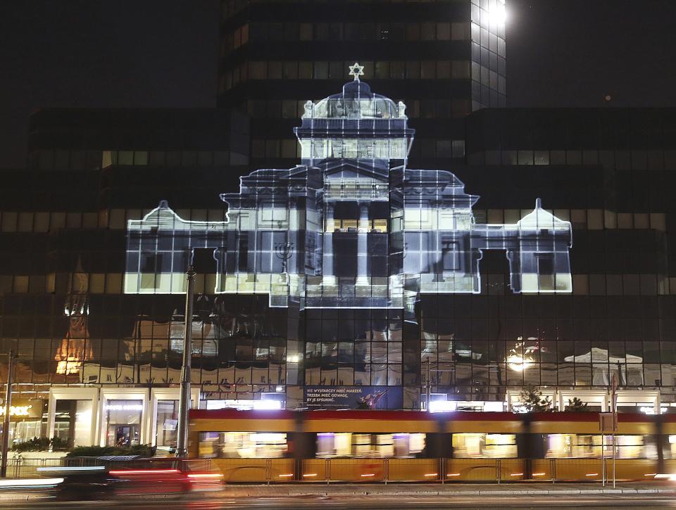 The Great Synagogue of Warsaw, which was destroyed by the German forces during World War II, was recreated virtually with light as part of anniversary commemorations of the 1943 uprising in the Warsaw Ghetto, in Warsaw, Poland, Thursday, April 18, 2019. The multimedia installation, which included the archival recordings of a prewar cantor killed in the Holocaust, is the work of Polish artist Gabi von Seltmann. It was organized by a group that fights anti-Semitism.(AP Photo/Czarek Sokolowski)