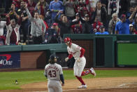Philadelphia Phillies' Rhys Hoskins watches his home run off Houston Astros starting pitcher Lance McCullers Jr. during the = inning in Game 3 of baseball's World Series between the Houston Astros and the Philadelphia Phillies on Tuesday, Nov. 1, 2022, in Philadelphia. (AP Photo/Matt Rourke)