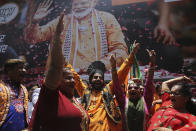 Bharatiya Janata Party (BJP) workers celebrate outside BJP headquarters in Mumbai, India, Thursday, May 23, 2019. Indian Prime Minister Narendra Modi and his party were off to an early lead as vote counting began Thursday following the conclusion of the country's 6-week-long general election, sending the stock market soaring in anticipation of another five-year term for the Hindu nationalist leader. (AP Photo/Rafiq Maqbool)