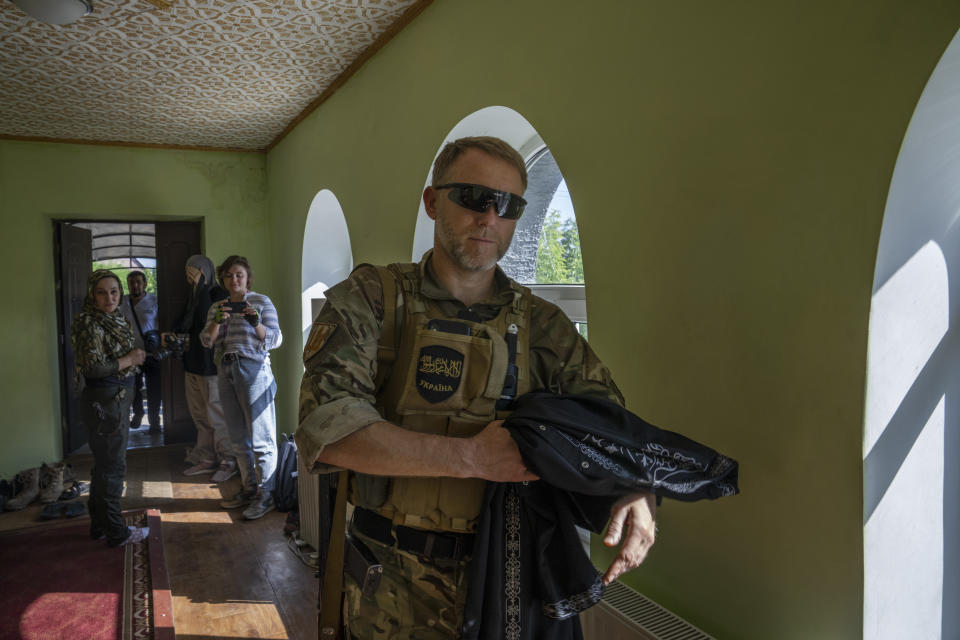 Former Mufti-turned-fighter Sheikh Said Ismahilov, arrives to lead Muslim soldiers for prayers on the first day of Eid al-Adha, in Medina Mosque, Konstantinovka, eastern Ukraine, Saturday, July 9, 2022. (AP Photo/Nariman El-Mofty)