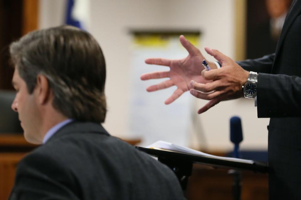 Bill Ogden, a lawyer representing Neil Heslin and Scarlett Lewis, motions with his hands toward Andino Reynal, a lawyer for Alex Jones, during the trial Monday.
