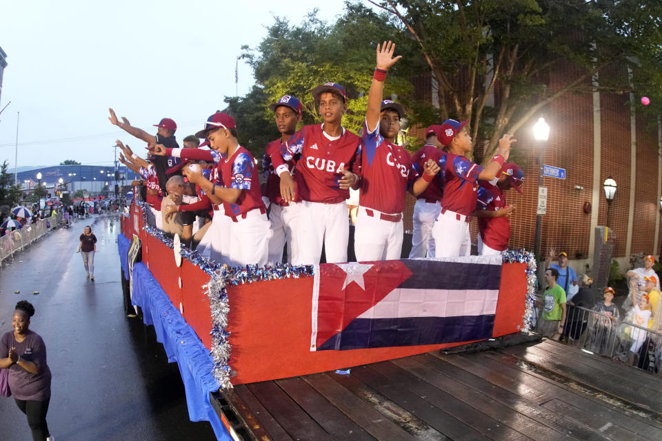 The Cuba Region champion Little League team from Bayamo, Cuba, rides in the Little League Grand Slam Parade in downtown Williamsport, Pa., Monday, Aug. 14, 2023. The Little League World Series baseball tournament, featuring 20 teams from around the world, starts later in the week in South Williamsport, Pa. (AP Photo/Gene J. Puskar)