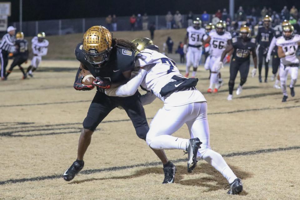 Shelby's Izay Bridges looks to break free of a Reidsville tackler during their Class 2A football playoff matchup on Friday, Nov. 26.