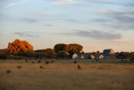 Facilities, that are not part of the actor Alec Baldwin production, are pictured at sunset in the Bonanza Creek Film Ranch in Santa Fe, N.M. Friday, Oct. 22, 2021. Baldwin fired a prop gun on the set of a Western being filmed at the ranch on Thursday, Oct. 21, killing the cinematographer, officials said. The director of the movie was wounded, and authorities were investigating. (AP Photo/Andres Leighton)