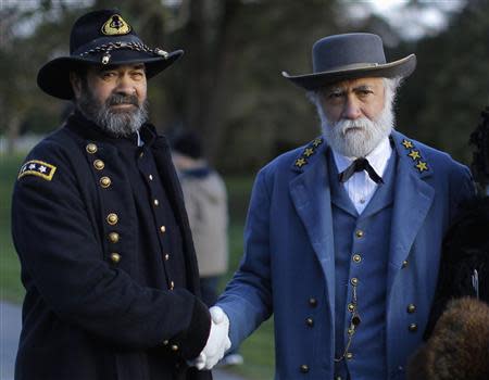 U.S. Civil War re-enactors portraying Union Lt. General George Meade (L) and Confederate General Robert E. Lee (R) shake hands at the Gettysburg National Cemetery in Pennsylvania November 19, 2013, the burial ground for Civil War Union soldiers in which U.S. President Abraham Lincoln travelled to in 1863 to deliver a few concluding remarks at a formal dedication. REUTERS/Gary Cameron