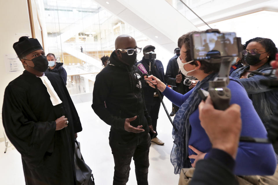 An activist from a group called the Anti-Negrophobia Brigade, Franco Lollia, wears a face mask reading « Anti-Negrophobia Brigade » as he talks to media at the Paris courthouse, in Paris, May 10, 2021. Lollia stands accused of covering in graffiti a statue that honours Jean-Baptiste Colbert, a 17th century royal minister who wrote rules governing slaves in France's overseas colonies. (AP Photo/Thibault Camus)