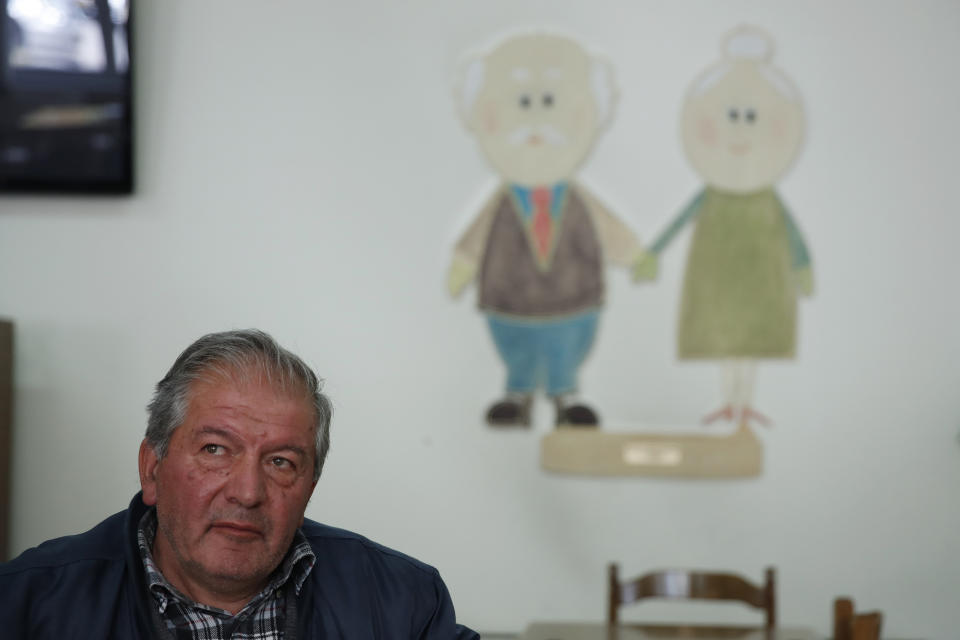 In this Tuesday, May 14, 2019, photo Vassilios Ragios retired carpenter, 63, sits at a community center for the retired in Karpenisi town at Evrytania region, in central Greece. The area, a winding, three-hour drive from Athens, has the oldest population in the whole European Union, 54.3 on average. (AP Photo/Thanassis Stavrakis)