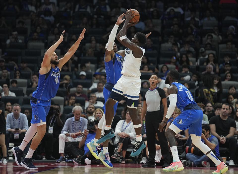 Minnesota Timberwolves' Anthony Edwards shoots over the Dallas Mavericks defense during a preseason NBA basketball game between the Dallas Mavericks and Minnesota Timberwolves in Abu Dhabi, United Arab Emirates in Abu Dhabi, United Arab Emirates, Saturday, Oct. 7, 2023. (AP Photo/Kamran Jebreili)