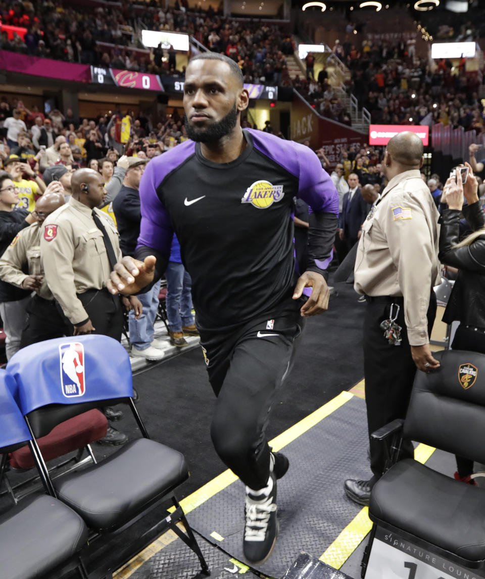 Los Angeles Lakers' LeBron James enters the court before the team's NBA basketball game against the Cleveland Cavaliers, Wednesday, Nov. 21, 2018, in Cleveland. (AP Photo/Tony Dejak)
