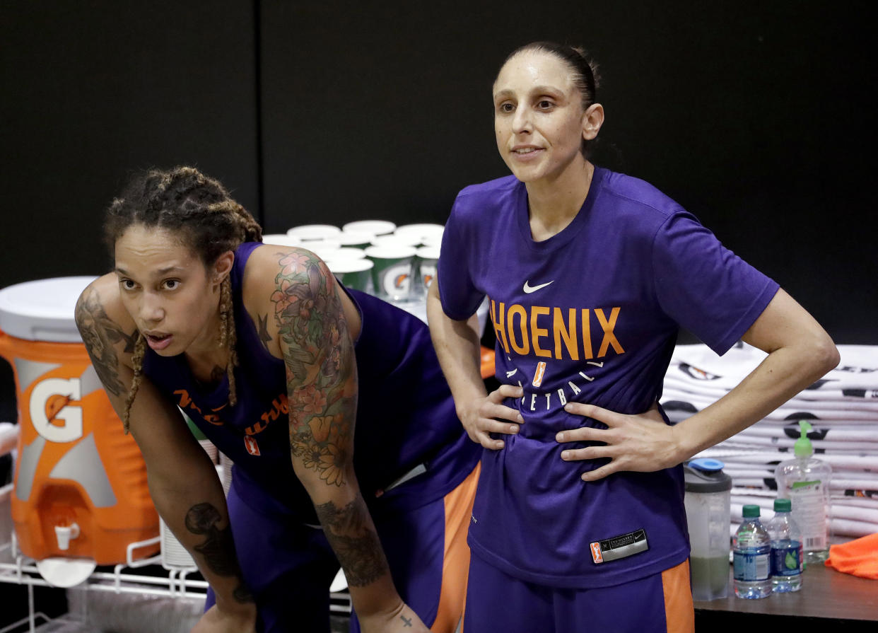 Phoenix Mercury's Brittney Griner, left, watches practice with teammate Diana Taurasi on Thursday, May 10, 2018, in Phoenix. Griner, the 2017 WNBA scoring champion, is back from Russia and ready her upcoming season with the Mercury.(AP Photo/Matt York)