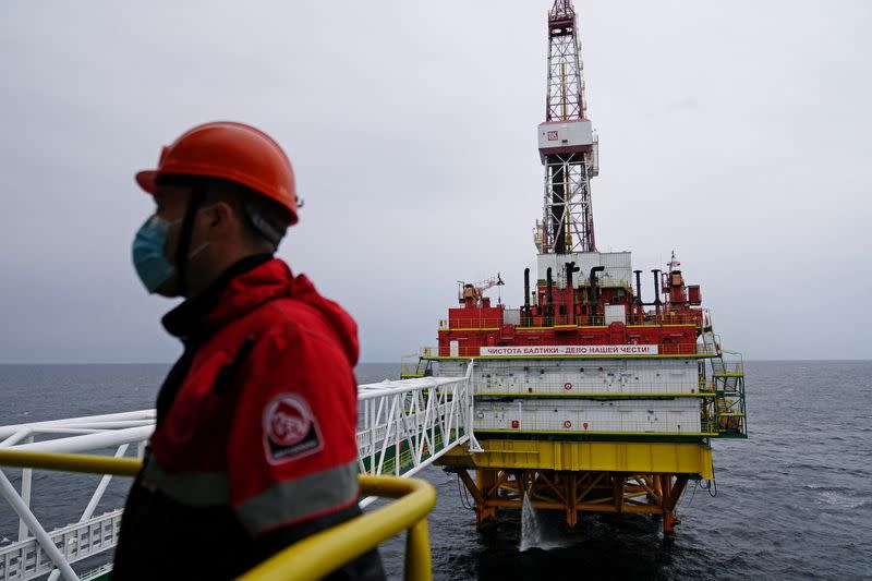 FILE PHOTO: An employee is seen at an oil platform operated by Lukoil company at the Kravtsovskoye oilfield in the Baltic Sea