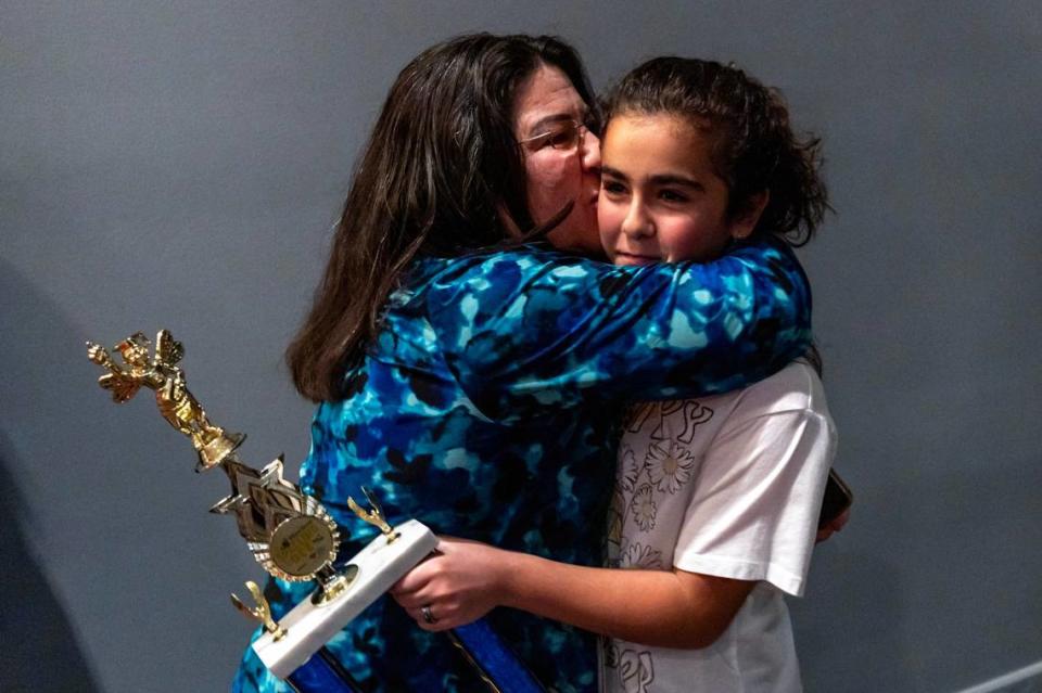 Neisy Mirabal hugs her daughter Jasmine Perez after she won first place during the Miami Herald Broward County Spelling Bee by spelling “Huckleberry” and “Merriment” at NSU Art Museum in Fort Lauderdale, Florida on Thursday, March 7, 2024. D.A. Varela/dvarela@miamiherald.com