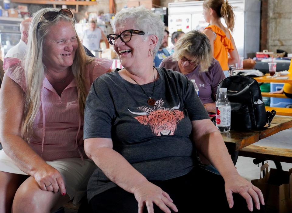 Lori Galanti, of Milan, shares a laugh with Deb Erskine, 70, of Chelsea, during the 115th annual Rendel Family Reunion in Milan on July 30, 2023.