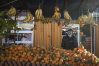 A fruit vendor wearing a face mask waits for clients in a daily market in Dakhla, Western Sahara, Monday, Dec. 21, 2020. U.S. plans to open a consulate in Western Sahara mark a turning point for the disputed and closely policed territory. U.S. recognition of Morocco’s authority over the land frustrates indigenous Sahrawis seeking independence. But others see the future U.S. consulate as a major boost for Western Sahara cities like Dakhla. (AP Photo/Mosa'ab Elshamy)