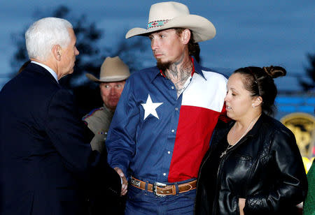 U.S. Vice President Mike Pence shakes hands with Johnnie Langendorff, who was one of the heroes that chased the assailant, near the site of the shooting at the First Baptist Church of Sutherland Springs in Sutherland Springs, Texas, U.S., November 8, 2017. REUTERS/Jonathan Bachman