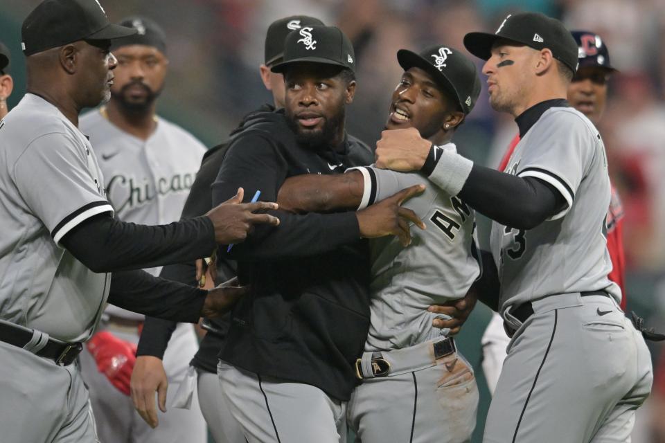 Teammates holds back White Sox shortstop Tim Anderson (7) after Anderson and Jose Ramirez (not pictured) got into a fight during the sixth inning Saturday.