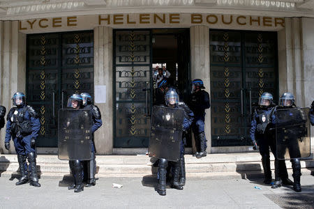 French CRS riot police secure the entrance to Lycee Helene Boucher during a demonstration by high school students to protest the results of the first round of the presidential election in Paris, France, April 27, 2017. REUTERS/Gonzalo Fuentes