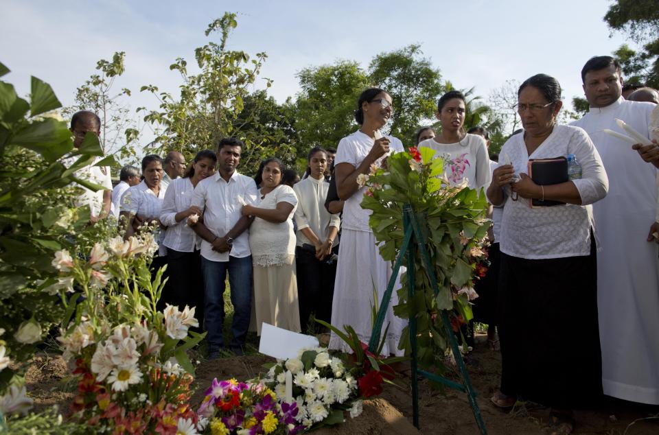 Family members mourn at the burial of seven-years old Dhulodh Anthony, a victim of Easter Sunday bomb blast at Methodist cemetery in Negombo, Sri Lanka, Tuesday, April 23, 2019. (AP Photo/Gemunu Amarasinghe)