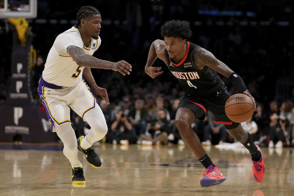 Houston Rockets guard Jalen Green (4) drives against Los Angeles Lakers forward Cam Reddish (5) during the first half of an NBA basketball game in Los Angeles, Sunday, Nov. 19, 2023. (AP Photo/Eric Thayer)