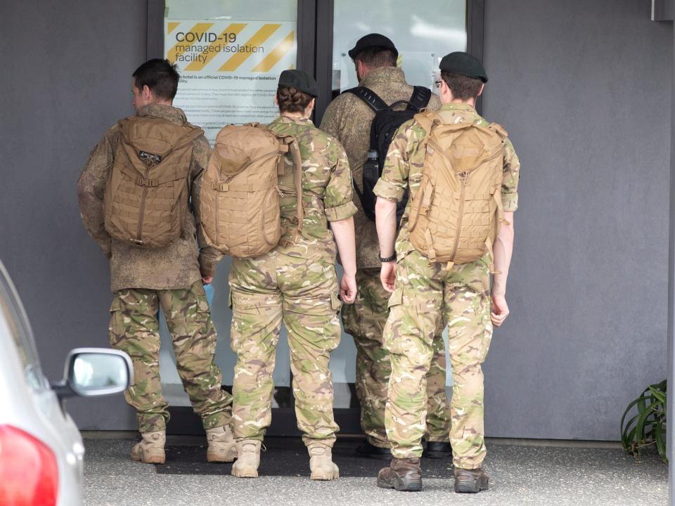 Military personnel arrive at the Sudima Hotel in Christchurch, New Zealand, after fishermen tested positive for Covid (AP)