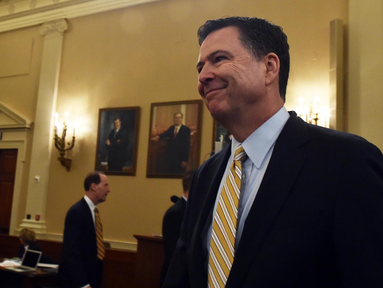 FBI Director James Comey smiles after a break in the House Permanent Select Committee on Intelligence hearing on Russian actions in the 2016 election campaign: AFP/Getty Images