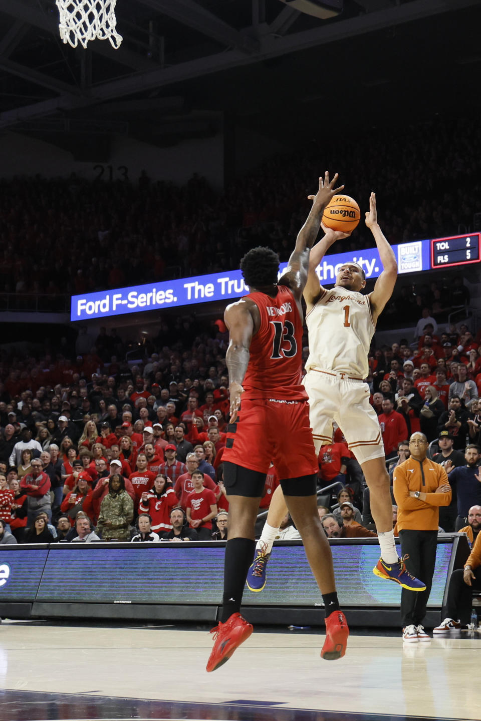 Texas' Dylan Disu, right, shoots over Cincinnati's Jamille Reynolds during the second half of an NCAA college basketball game Tuesday, Jan. 9, 2024, in Cincinnati. (AP Photo/Jay LaPrete)