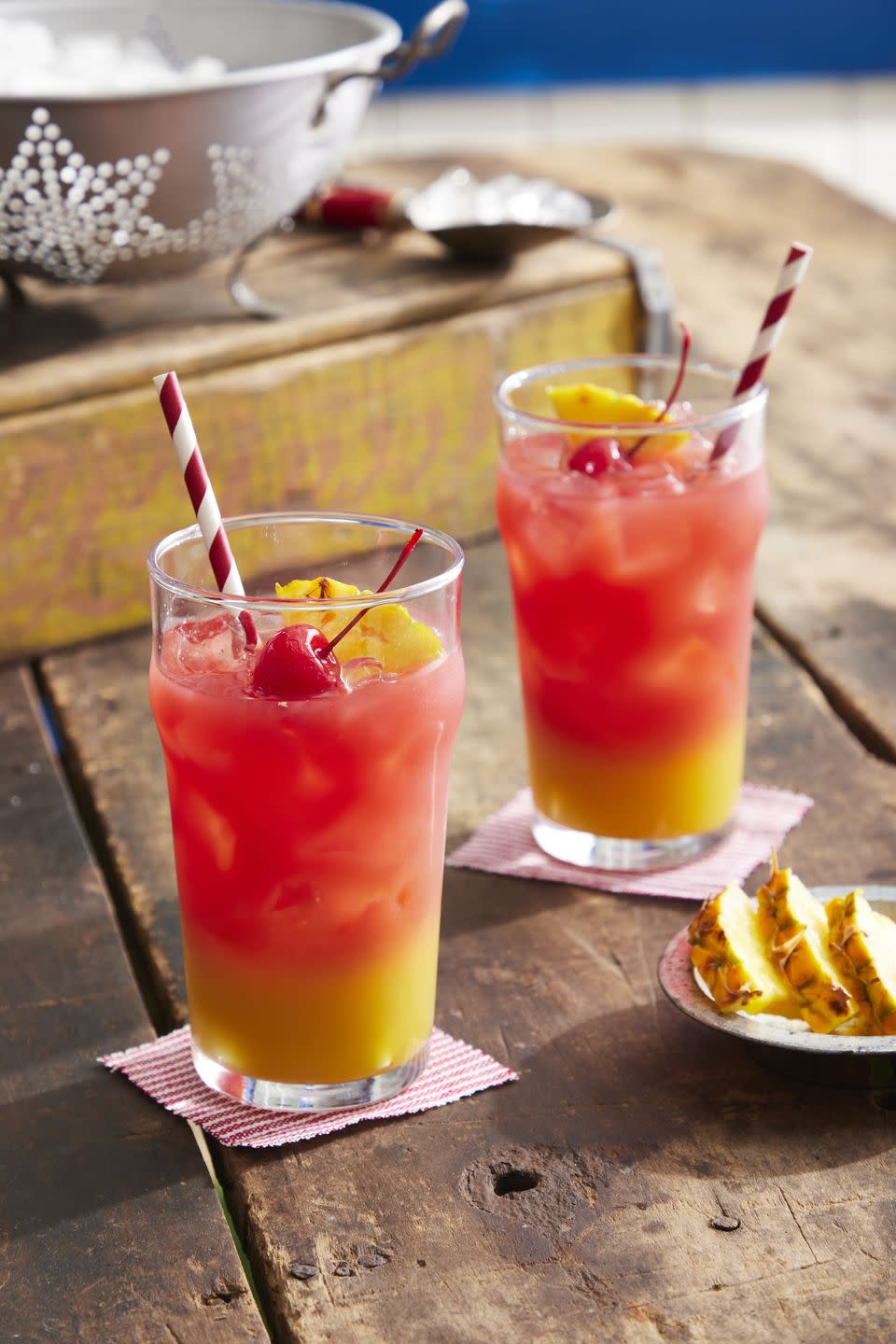 sailors warning cocktail in glasses with ice and garnished with a cherry and slice of pineapple