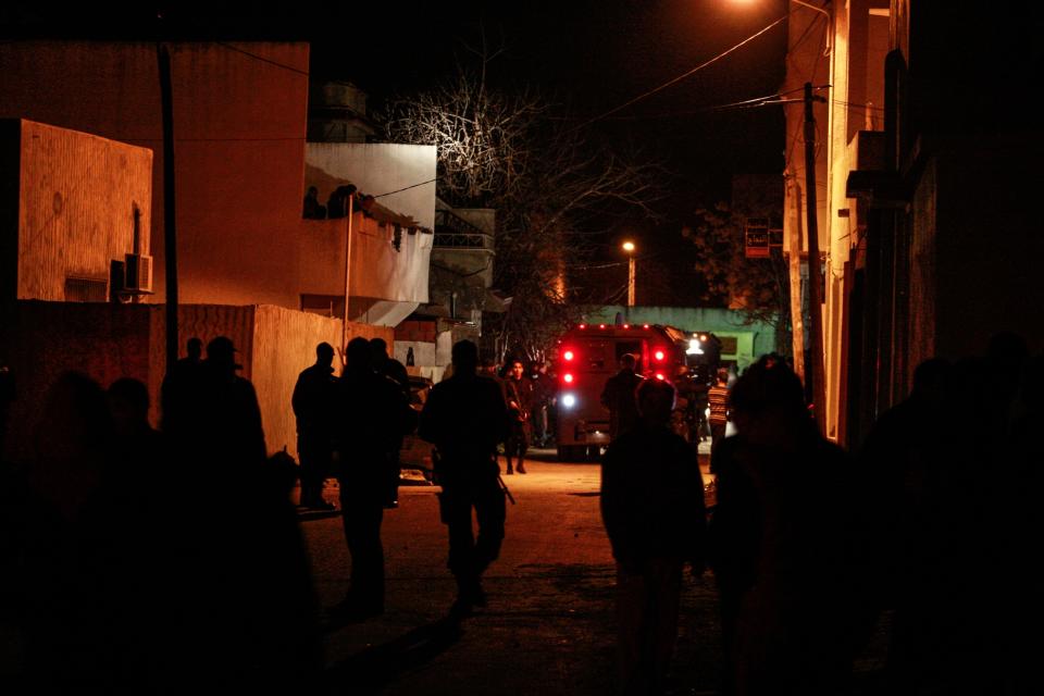 Tunisian counterterrorist forces patrol near the house of Ahmed Melk, a wanted militant, in Bourj Louzir, outside Tunis, Sunday, Feb. 9, 2014. Tunisia's government says the suspect in the July 25 assassination of an opposition politician is among four men arrested in an overnight counterterrorism raid. The Interior Ministry statement Sunday described the men as "dangerous terrorists" and identified one as Ahmed Melki, known as the "Somali" who is wanted in connected with the assassination of Mohammed Brahmi, a left-wing parliamentarian whose slaying last summer provoked a political crisis. (AP Photo/Aimen Zine)