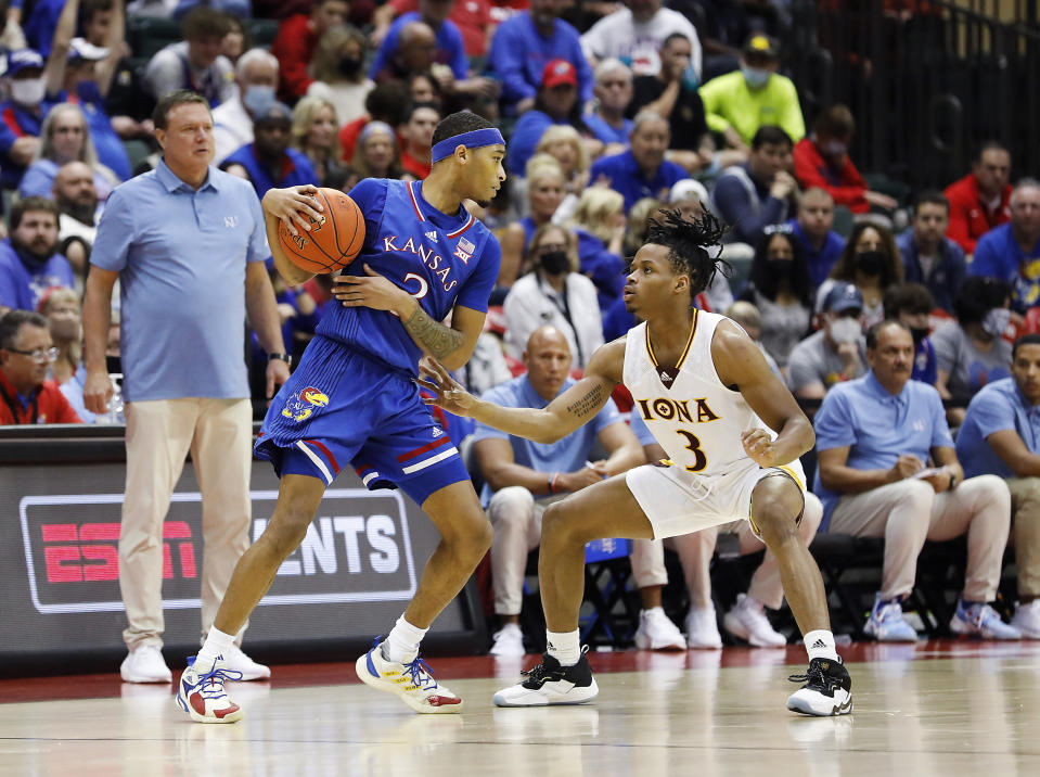 Iona guard Ryan Myers defends Kansas guard Christian Braun, left, during the second half of an NCAA college basketball game Sunday, Nov. 28, 2021, in Lake Buena Vista, Fla. (AP Photo/Jacob M. Langston)