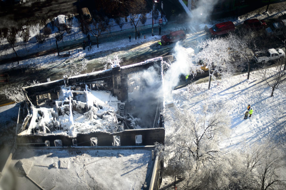 The collapsed rooftop and charred remains is shown on Thursday, Jan. 2, 2014, in Minneapolis, after Wednesday's fire destroyed the building. Fourteen were injured and the cause of the fire is still unclear. (AP Photo/The Star Tribune, Glen Stubbe) MANDATORY CREDIT; ST. PAUL PIONEER PRESS OUT; MAGS OUT; TWIN CITIES TV OUT