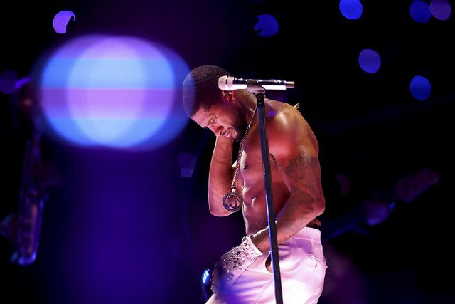 <p>Ezra Shaw/Getty</p> Usher performs at the Super Bowl LVIII halftime show