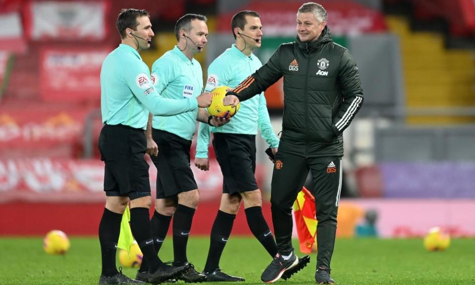 Ole Gunnar Solskjær bumps fists with the officials after the 0-0 draw at Anfield