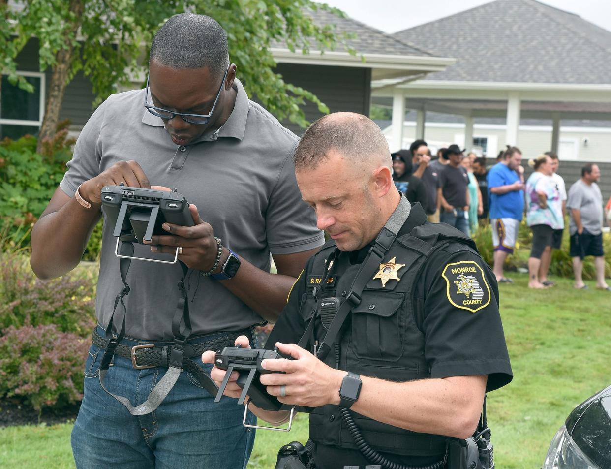 Michigan Lt. Governor Garlin Gilchrist watches live drown images and footage of the storm damage from a tornado that touched down in August at Frenchtown Villa in Monroe County. Controlling the drone was Monroe County Sheriff Capt. Dave Raymond.