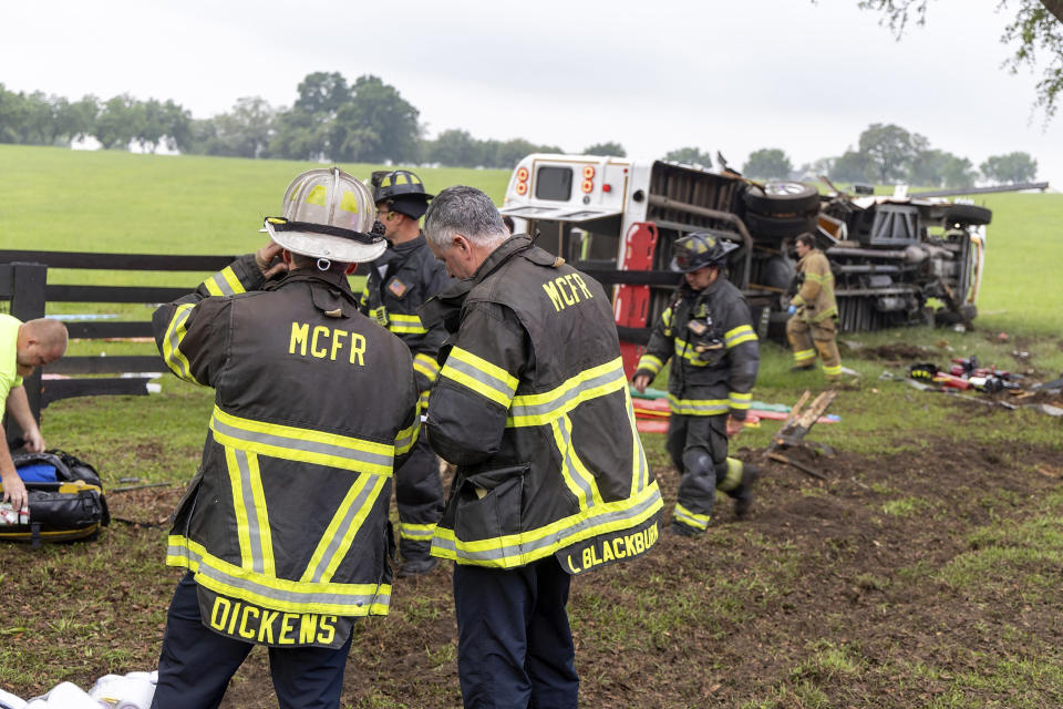 This photo provided by the Marion County Fire Rescue Dept. shows crews from Marion County Fire Rescue and the Marion County Sheriff’s Office assisting victims after a bus carrying farmworkers crashed and overturned early Tuesday, May 14, 2024 near Ocala, Fla. The Florida Highway Patrol says eight people were killed and nearly 40 others were injured. (Marion County Fire Rescue Dept. via AP)