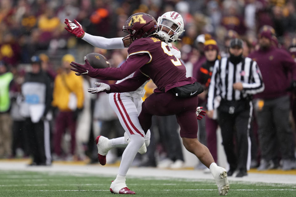 Minnesota wide receiver Daniel Jackson (9) attempts to catch a pass as Wisconsin cornerback Nyzier Fourqurean defends during the first half of an NCAA college football game Saturday, Nov. 25, 2023, in Minneapolis. Fourqurean was called for pass interference on the play. (AP Photo/Abbie Parr)