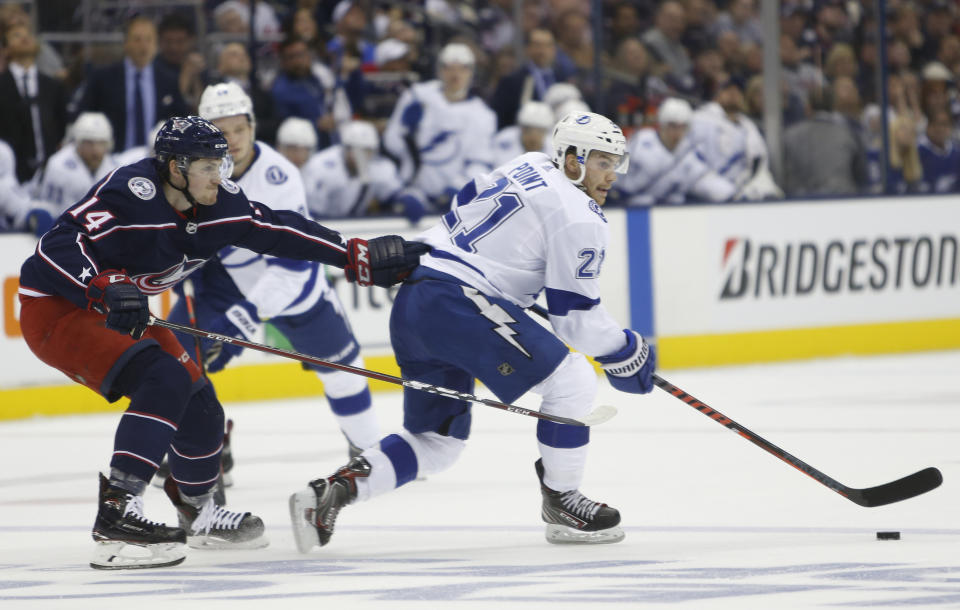 Tampa Bay Lightning's Brayden Point, right, looks for an open pass as Columbus Blue Jackets' Dean Kukan, of Switzerland, defends during the first period of Game 3 of an NHL hockey first-round playoff series Sunday, April 14, 2019, in Columbus, Ohio. (AP Photo/Jay LaPrete)