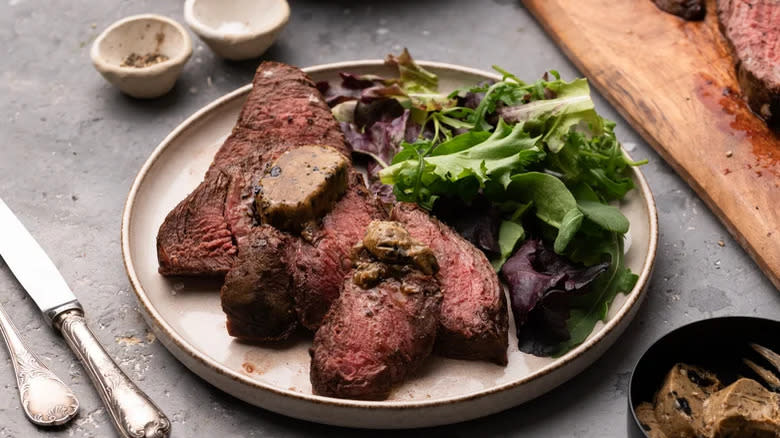 steak with butter and greens